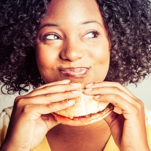 image of women with a burger representing food service indusry